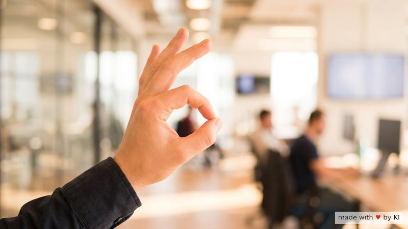 Eine Hand drückt einen Daumen an den Zeigefinger als Anker-Geste vor einem Bürofenster im Sonnenlicht - Selbsthypnose-Reset zwischen Terminen